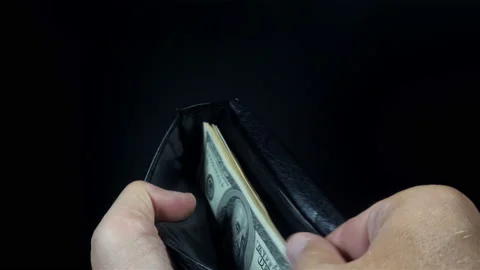 Hands open a wallet with dollar bills inside in 4K. Stock Footage 139229424