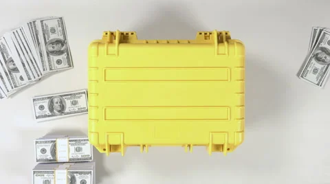 Hands open an yellow protect case full of stacks of hundred dollar bills. Stock Footage 61150672
