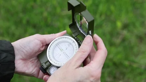 Hands Opening and Closing Green Military Compass Outdoors Stock Footage 341343468