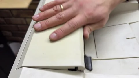 Hands opening and closing the top cover of a home or office printer. Close up of Stock Footage 336977292