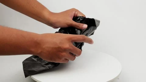 Hands Opening a Black Plastic Bag Stock Footage 327848754