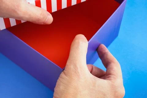 Hands opening a cardboard box Stock Photos