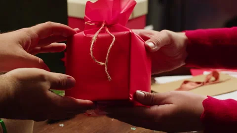 Hands Opening Christmas new year or birthday gift box on a wooden desktop Stock Footage 253576085