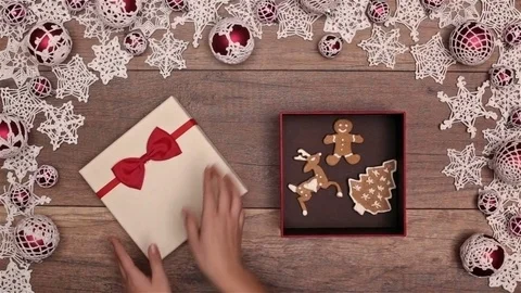 Hands opening christmas present inside a seasonal decorations frame Video stock 81170004