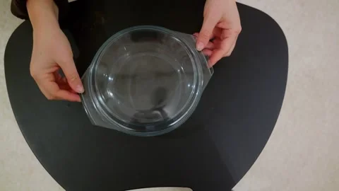 Hands opening a clear glass baking dish Stock Footage 332450245