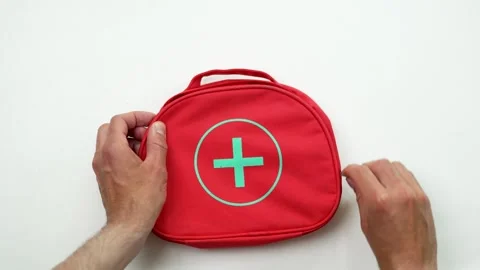 Hands Opening First Aid Kit on White Background, Emergency Preparedness Concept Stock Footage 309878812