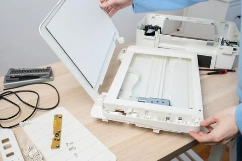 Hands Opening Flatbed Scanner For Printer Repair And Maintenance On Wooden .. Stock Photos
