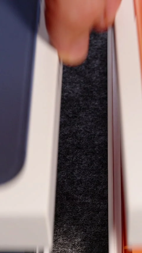 Hands Opening iPhone 17 Pro Boxes in Deep Blue and Cosmic Orange Colors on Gray Video stock 318056935