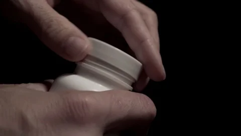 Hands opening a jar of pills closeup Stock Footage 94601013