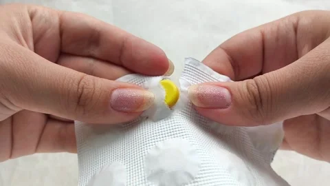 Hands opening a package of pills against. The concept of treatment. Stock Footage 314880064
