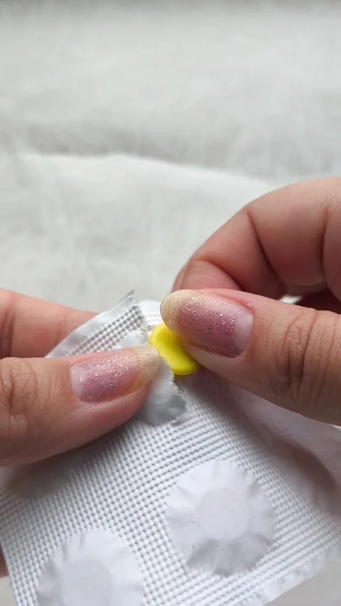 Hands opening a package of pills against. The concept of treatment. Видео 314880102