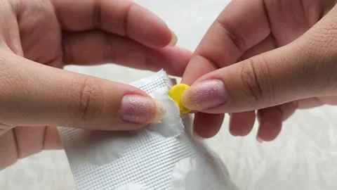 Hands opening a package of pills against. The concept of treatment. Видео 314880280