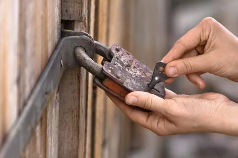 Hands opening the padlock Stock Photos