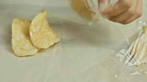 Hands opening plastic packaging then breaking crispy sweet crackers and pla.. Stock Footage 324820235