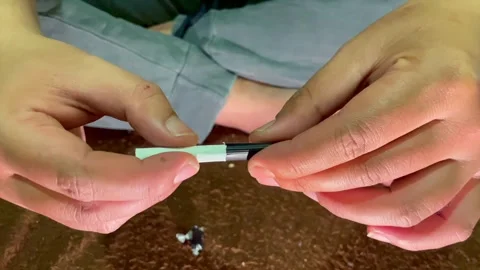 Hands opening plastic wrapper of a single cigarette Stock-Footage 339526332