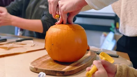 Hands Opening Pumpkin During Halloween Carving Activity Vídeos de archivo 345094644