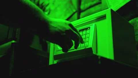Hands opening safe in dark room . Man drives the PIN code at the strongbox Stock Footage 197411566