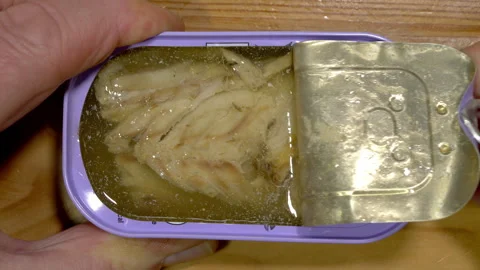Hands opening a tin can of mackerel fillets in spring water. Stock-Footage 262645667