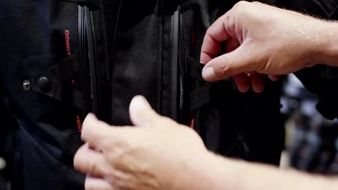 Hands Opening Ventilation Zipper on Black Motorcycle Jacket, Close Up Shot Stock Footage 341444488