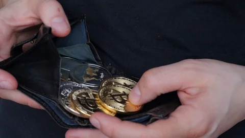 Hands opening wallet full of cryptocurrency coins, bitcoins Stock Footage 88424618