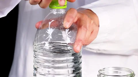 Hands Opening Water Bottle in Laboratory Setting Stock Footage 306334342