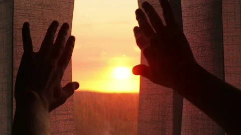 Hands opening the window blinds against the backdrop of the setting sun Stock-Footage 91487934