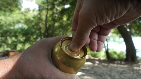 Hands opens a can of beer in slow motion of a natural landscape Stock Footage 137027324