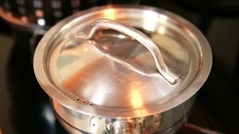 Hands opens the lid of the pan cook beans preparation vegetable diet restaurant Video stock 112620492