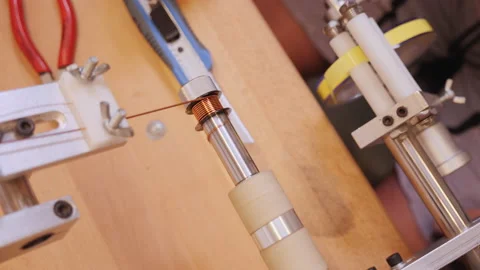 Hands operate coil winding machine, making electronic component Video stock 150441187