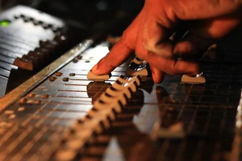 Hands operating slider of light and sound board console at a concert theater Stock Photos