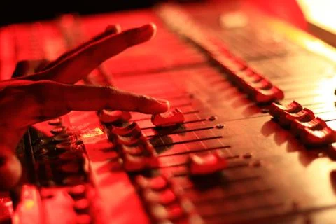 Hands operating slider of light and sound board console at a concert theater Stock Photos