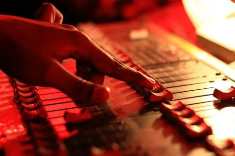Hands operating slider of light and sound board console at a concert theater Stock Photos