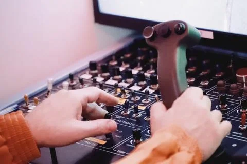 The hands of the operator controlling the robot manipulator on the robot cont Stock Photos