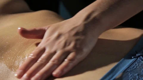 Hands of Osteopath doing manipulative massage on female abdomen. Massage therapy Stock Footage 120586497