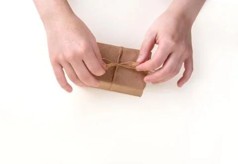 Hands pack a gift box. Space for text. Stock Photos