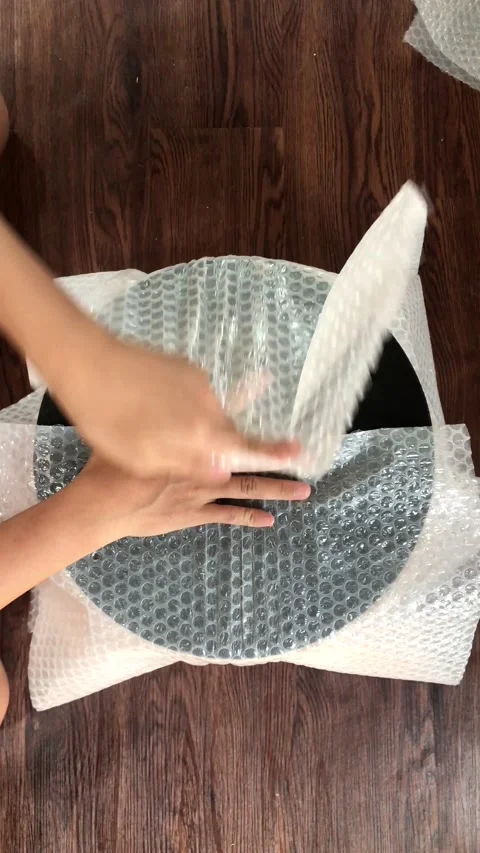 Hands Packaging Goods with Bubble Wrap and Tape for Shipping 4K Stock Footage 337720718