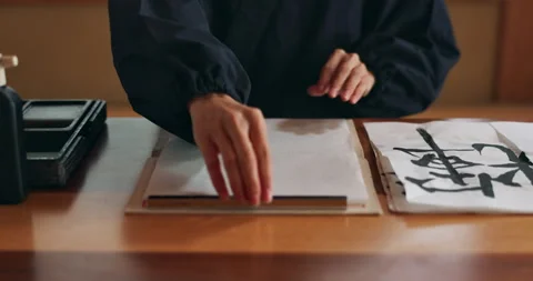 Hands, paper and writing with calligraphy or Asian script for art with inkstone Stock Footage 260285459
