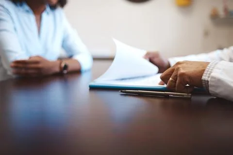 Hands, paperwork and pen at table for medical, application for health insurance Stock Photos