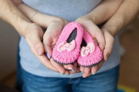 Hands of parents with booties 스톡 사진
