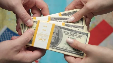 Hands pass stack of US dollars to Indonesia representative against world map Stock Footage 331263404