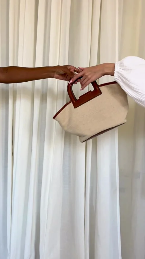 Hands passing a stylish canvas tote bag with handles 스톡 동영상 331770925