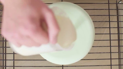 Hands of the pastry chef pouring multicolor mirror glaze on a big cake Video stock 98097327