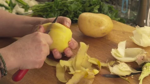 Hands peeling fresh potatoes with a knife Stock Footage 331313982