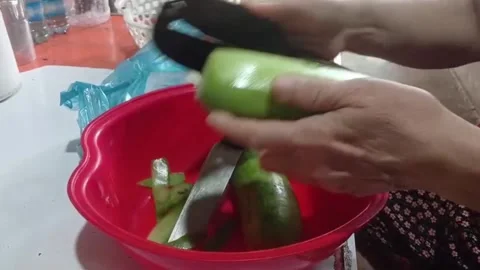 Hands Peeling Fresh Winter Melon for Soup Preparation in Vietnam Stock Footage 337154597