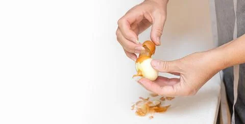 Hands peeling an onion Stock Photos