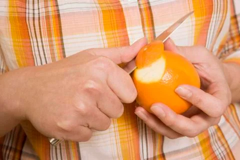 Hands Peeling Orange Stock Photos
