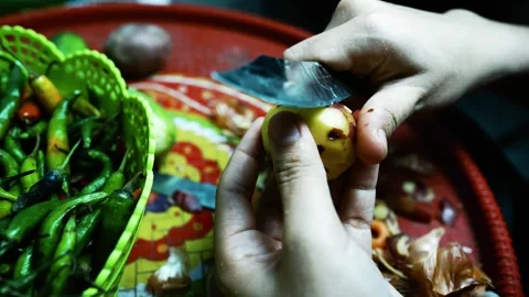 Hands Peeling a Potato with Vegetables, A close-up of hands peeling a potat.. Stock Footage 304978337