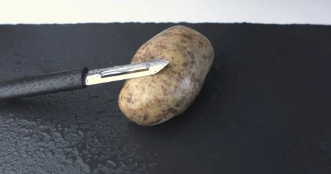 Hands peeling potatoes in the kitchen Stock Footage 122990066