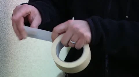 Hands peeling off tape Stock Footage 11924536