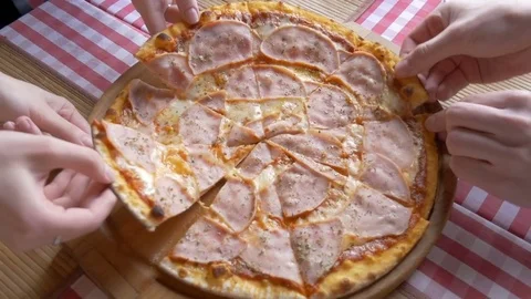 Hands of people, close-up, take slices of pizza, melted cheese which drips onto Stock Footage 75031674